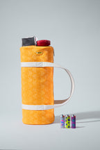 Orange thermos with colorful lighters on a gray background