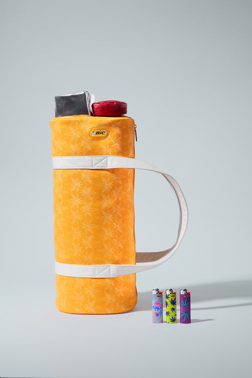 Orange thermos with colorful lighters on a gray background