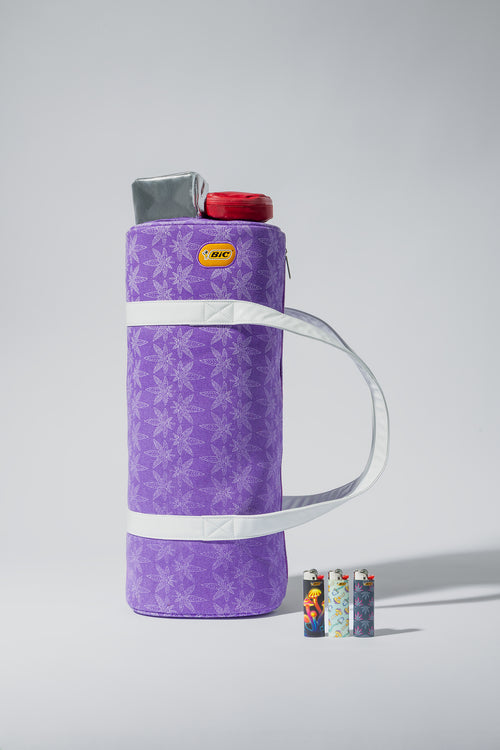Purple insulated bottle holder with white handle on a gray background